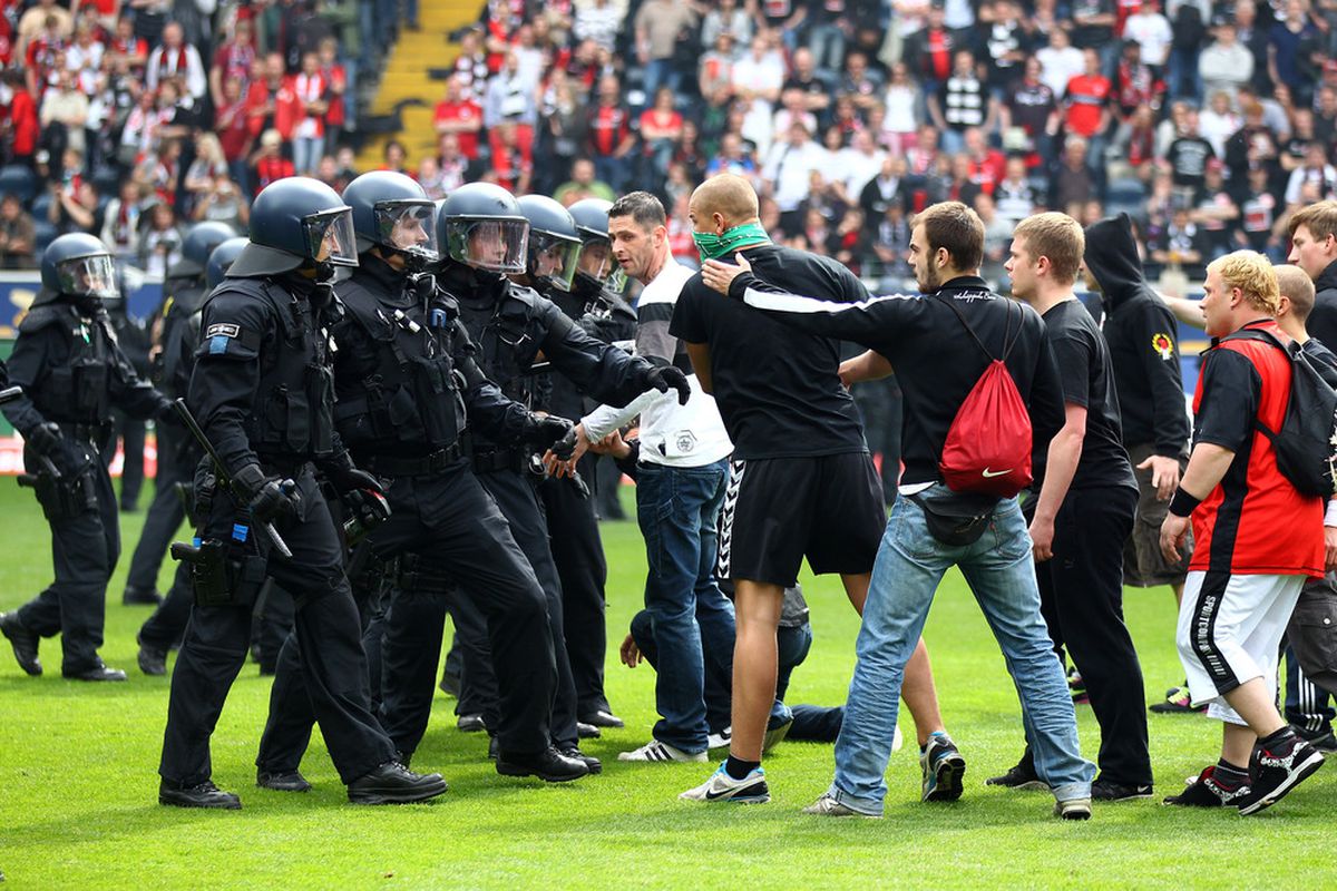 FRANKFURT AM MAIN, GERMANY - APRIL 29:  Hooligans of Frankfurt provoke the police after the ascent to the 1. Bundesliga. (Photo by Christof Koepsel/Bongarts/Getty Images)  Hooligans are one of the topics addressed in How Soccer Explains the World. 
