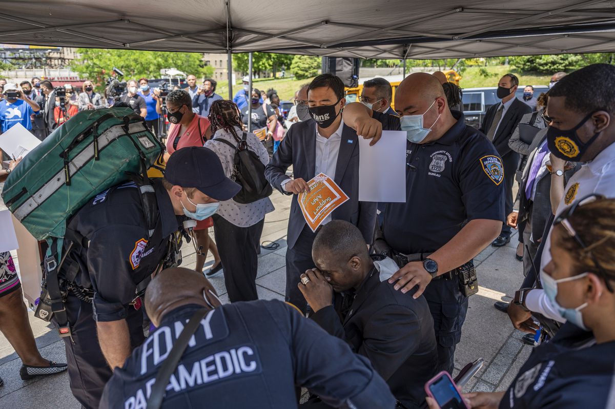 Mayoral candidate Andrew Yang helps fan a man who fainted at a campaign event in The Bronx, May 21, 2021.