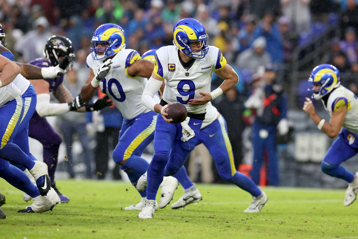 Quarterback Matthew Stafford of the Los Angeles Rams hands the ball off against the Baltimore Ravens at M&amp;T Bank Stadium on December 10, 2023 in Baltimore, Maryland.