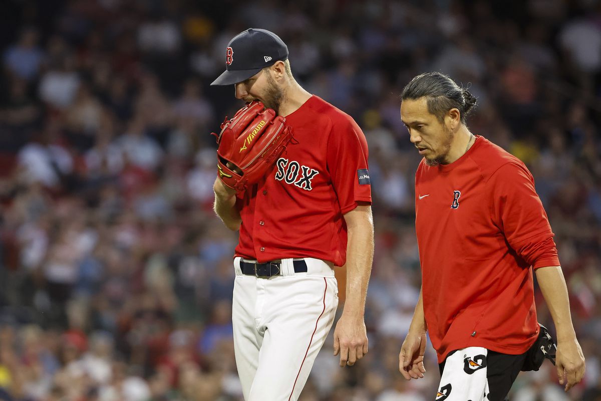 Chris Sale of the Boston Red Sox bites on his glove as he leaves the game in the middle of the fourth inning against the Cincinnati Reds at Fenway Park on June 1, 2023 in Boston, Massachusetts.
