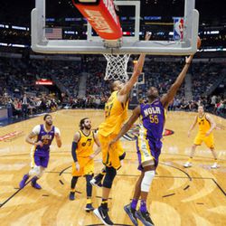 New Orleans Pelicans guard E'Twaun Moore (55) goes to the basket against Utah Jazz center Rudy Gobert (27) in the second half of an NBA basketball game in New Orleans, Monday, Feb. 5, 2018. The Jazz won 133-109. (AP Photo/Gerald Herbert)