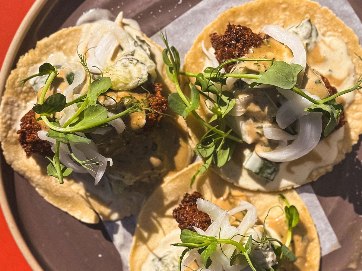 An overhead shot of three tacos on a plate