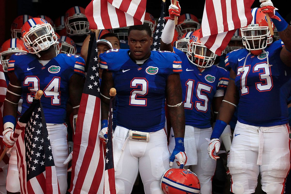 GAINESVILLE, FL - SEPTEMBER 10:  Players for the University of Florida Gators hold American flags before a game against the UAB Blazers at Ben Hill Griffin Stadium on September 10, 2011 in Gainesville, Florida.  (Photo by Sam Greenwood/Getty Images)