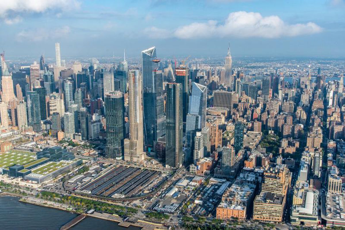 An aerial view of Hudson Yards and the many tall city buildings that surround it.
