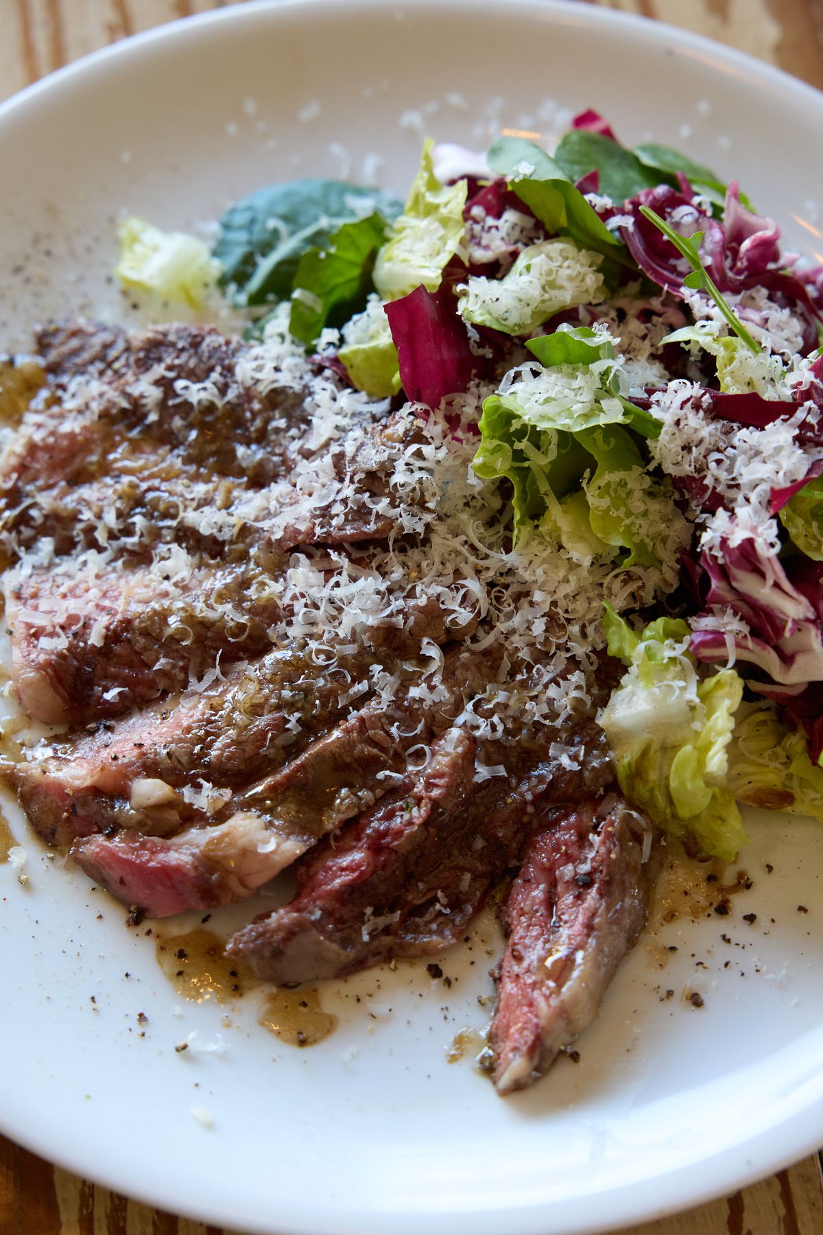 Sliced steak with salad.