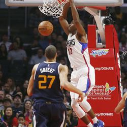 Los Angeles Clippers forward Luc Mbah a Moute dunks the ball while Utah Jazz center Rudy Gobert looks on during the first half of an NBA basketball game, Saturday, March 25, 2017, in Los Angeles. (AP Photo/Danny Moloshok)