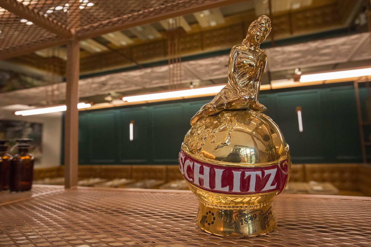 A golden Schlitz prop on a table.