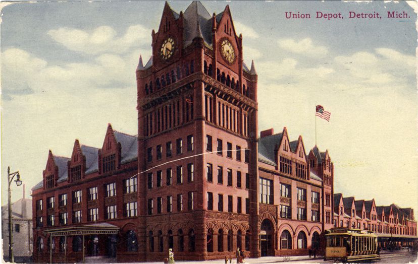 The exterior of Fort Street Union Depot in Detroit. The facade is red brick with a clock tower.