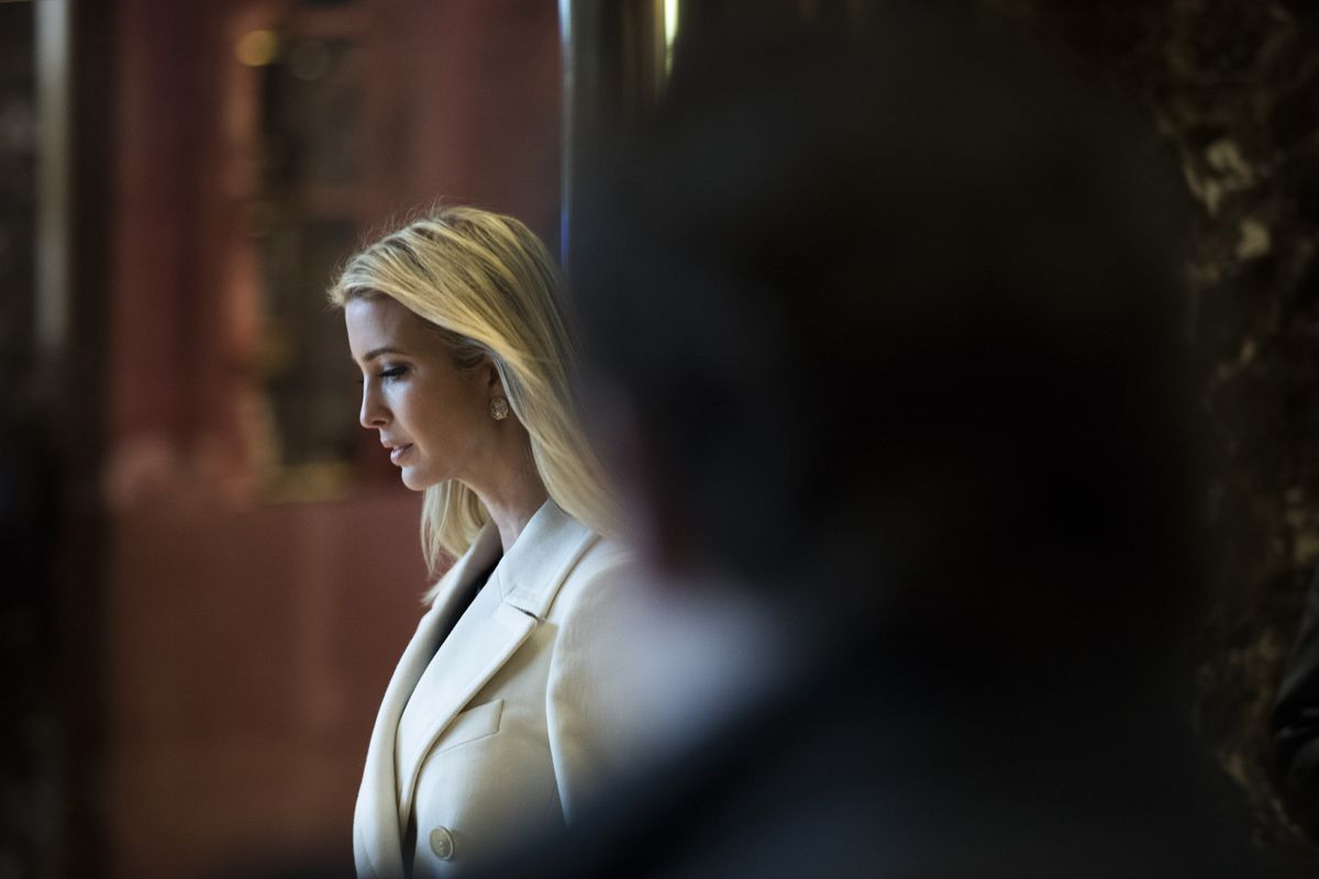 Ivanka Trump, wearing a white suit, departs her father’s building.