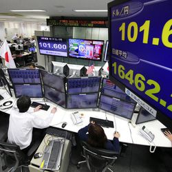Money traders watch computer screens with the day's exchange rate between yen and the U.S. dollar at a foreign exchange brokerage in Tokyo, Wednesday, Nov. 9, 2016.  Asian shares have shed early gains, tumbling Wednesday as Donald Trump gained the lead in the electoral vote count in the presidential election. Dow and S&P futures also plunged. Earlier, investors had appeared persuaded that Hillary Clinton, seen as a more stable choice, would prevail.