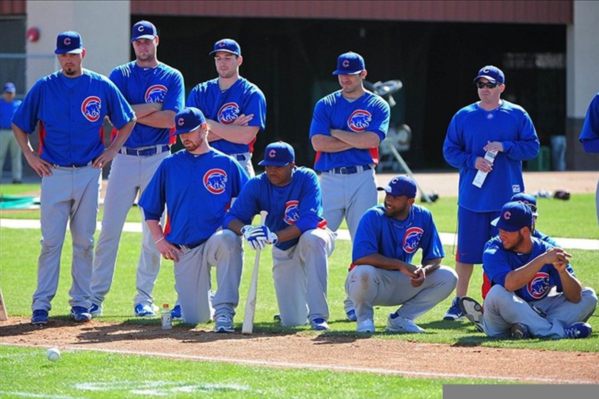 Mesa, AZ, USA; Chicago Cubs players watch the baseball roll after pitcher Chris Rusin bunted in the inaugural match play bunting tournament during spring training at Fitch Park. Mandatory Credit: Kyle Terada-US PRESSWIRE