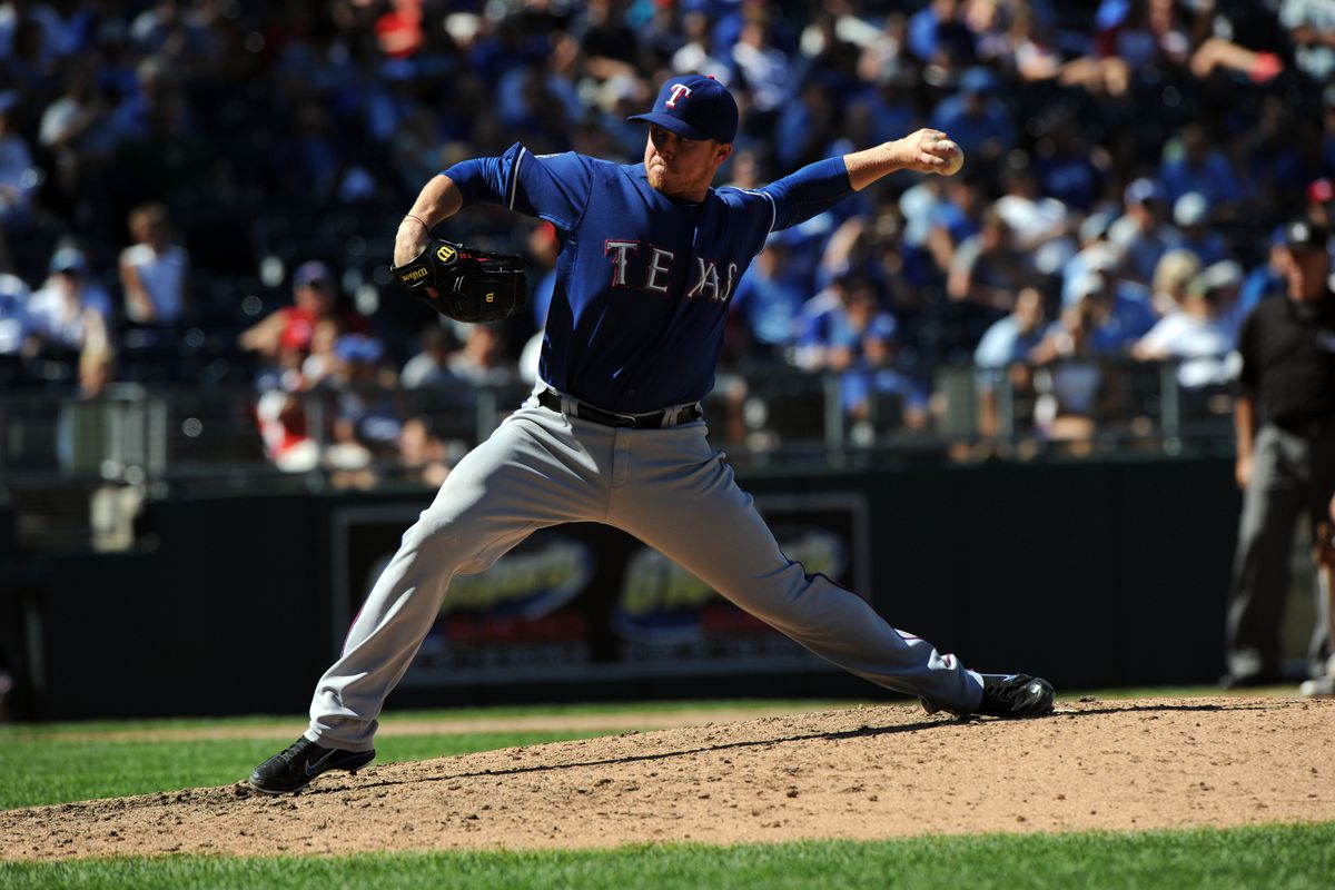 August 5, 2012; Kansas City, MO, USA; Texas Rangers pitcher Robbie Ross (28) delivers a pitch against the Kansas City Royals during the ninth inning at Kauffman Stadium.  Mandatory Credit: Peter G. Aiken-US PRESSWIRE