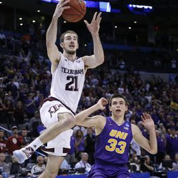 FILE - In this March 20, 2016, file photo, Texas A&M guard Alex Caruso (21) shoots in front of Northern Iowa guard Wyatt Lohaus (33) in the first overtime of a second-round men's college basketball game in the NCAA Tournament, in Oklahoma City. Caruso scored 25 points in the game. 