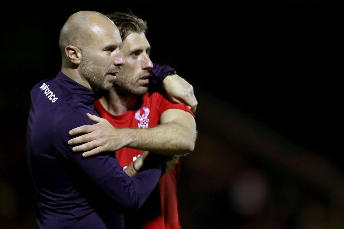 Kidderminster Harriers manager Russell Penn consoles a player at full-time after the National League North match at the Aggborough Stadium, Kidderminster. Picture date: Thursday May 12, 2021.