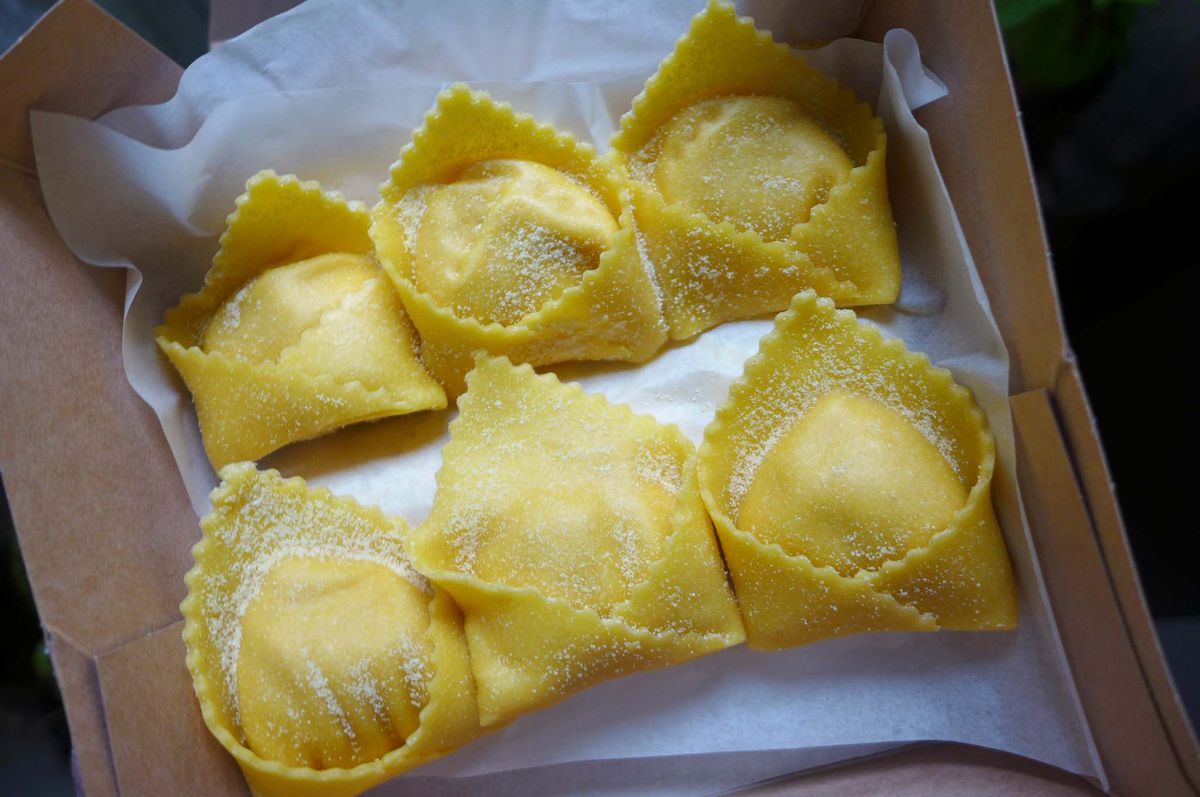 Six stuffed squares of pasta with a flap on each.