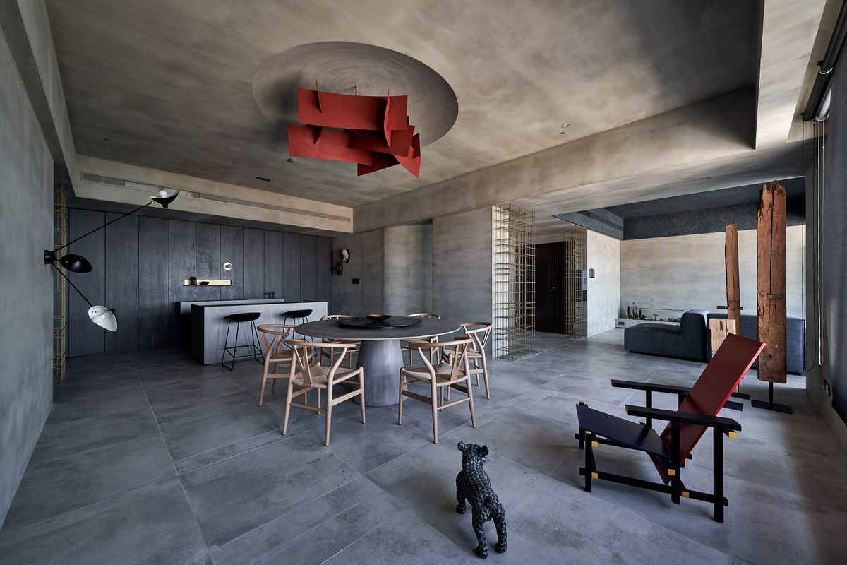 Concrete dining room with red pendant