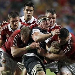 Imanol Harinordoq of the Barbarians, center, is tackled by players from the British and Irish Lions, during a 15-a-side rugby match, in Hong Kong, Saturday. The British & Irish Lions won 59-8.