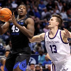 Brigham Young Cougars forward Fousseyni Traore (45) grabs a rebound ahead of Westminster Griffins forward Brayden Johnson (13) as BYU and Westminster play at the Marriott Center in Provo on Wednesday, Dec. 29, 2021. BYU won 65-53.