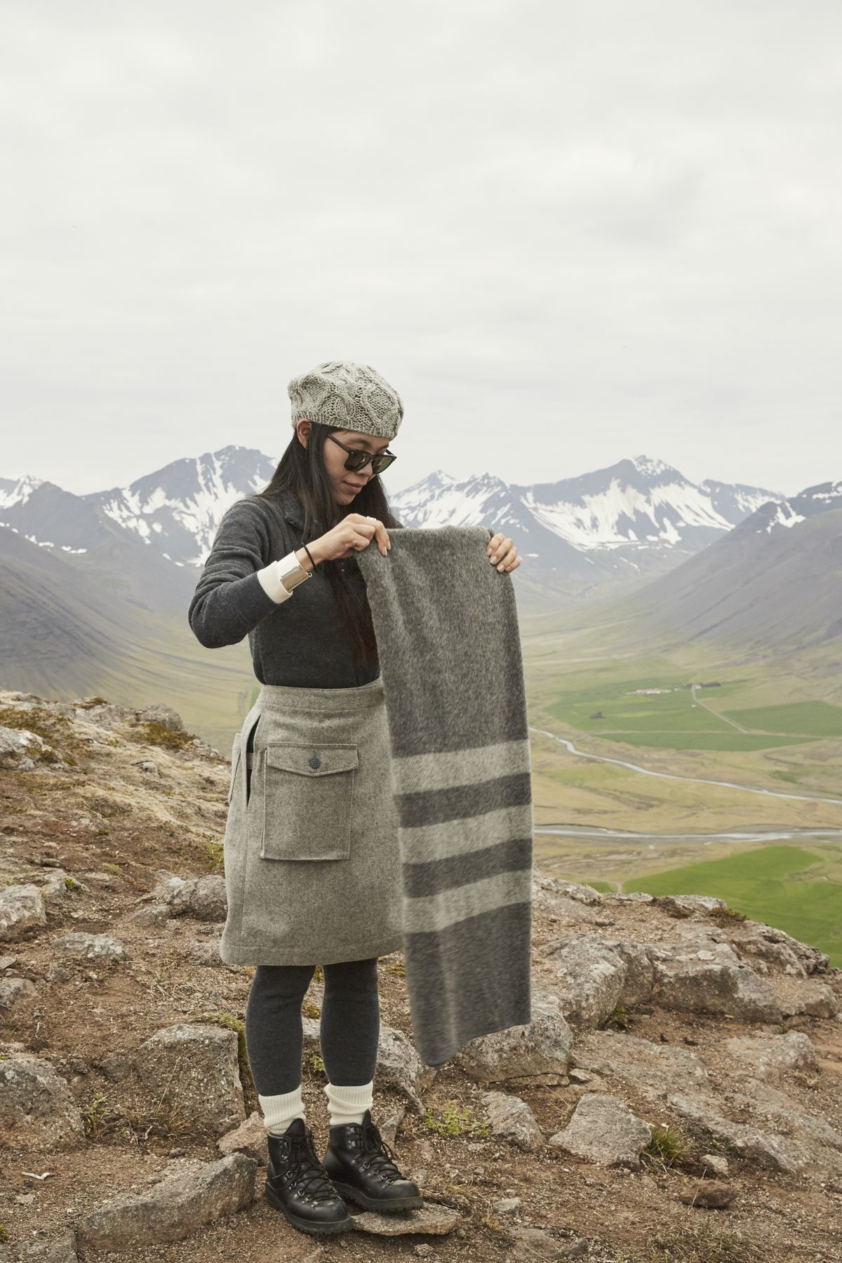 A woman folds a woolen poncho in Iceland