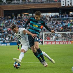 Hassani Dotson pulls the ball away from Marko Grujic during a friendly between Minnesota United and Hertha Berlin