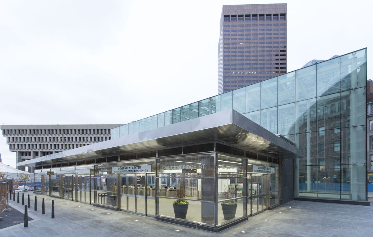 A long, glassy, somewhat squat head house for a subway station. 