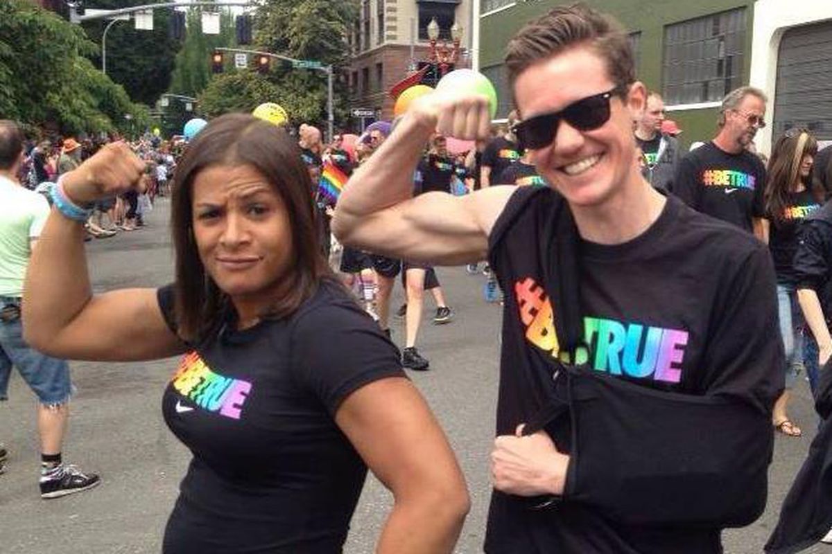 Fallon Fox and Chris Mosier flex during the Portland Pride Parade