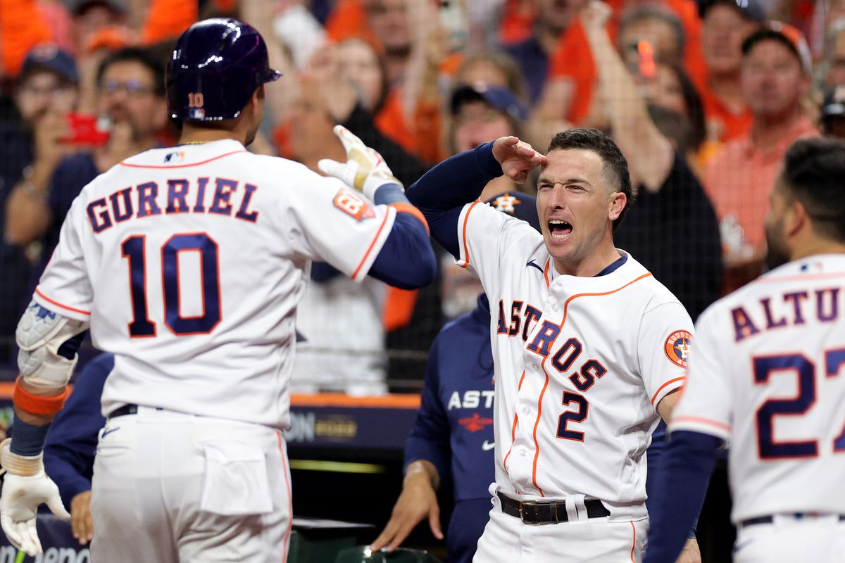 Yuli Gurriel of the Houston Astros celebrates a home run with Alex Bregman during the sixth inning against the New York Yankees in game one of the American League Championship Series at Minute Maid Park on October 19, 2022 in Houston, Texas.