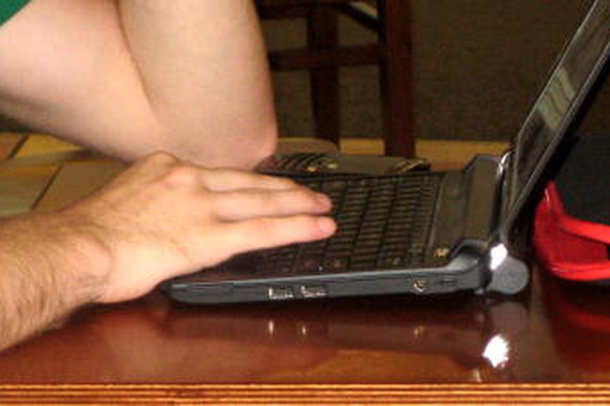A man types on his computer