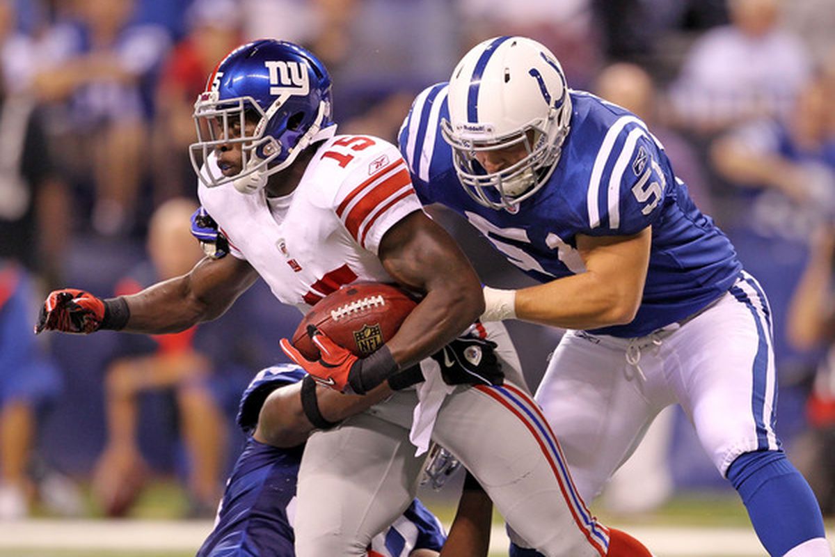 INDIANAPOLIS - SEPTEMBER 19: Darius Reynaud #15 of the New York Giants is tackled by Pat Angerer #51 of the Indianapolis Colts at Lucas Oil Stadium on September 19 2010 in Indianapolis Indiana.  (Photo by Andy Lyons/Getty Images)