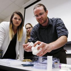Teacher Kevin R. Buckingham shows medical equipment to single moms during the Invest in You Too program at Salt Lake Community College in Sandy on Monday, Oct. 2, 2017. The Department of Workforce Services’ program is a 13-week course that helps single mothers build skills in medical manufacturing and job readiness to open doors for employment.