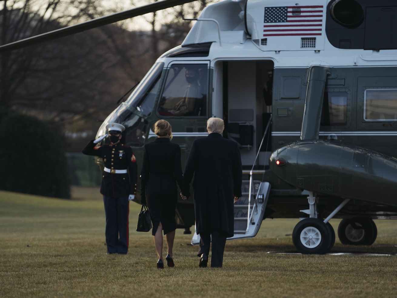 Donald and Melania Trump walk from the White House to the Marine One helicopter.
