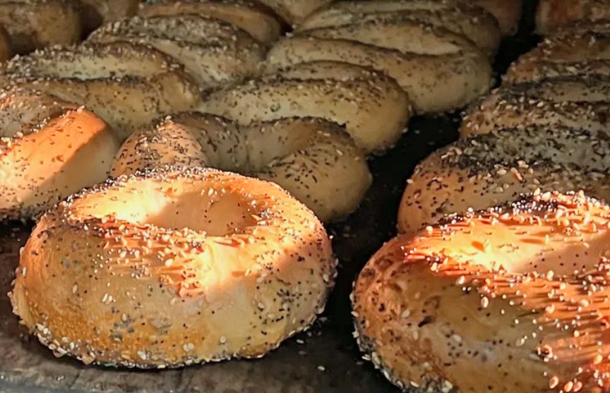 Rows of browned bagels still in the oven.