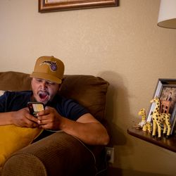 6:33 p.m.: Jimy yawns as he relaxes on the couch after a long day of work. He hopes his younger brothers, in photos at right, get the help they need to pursue college, he says.
