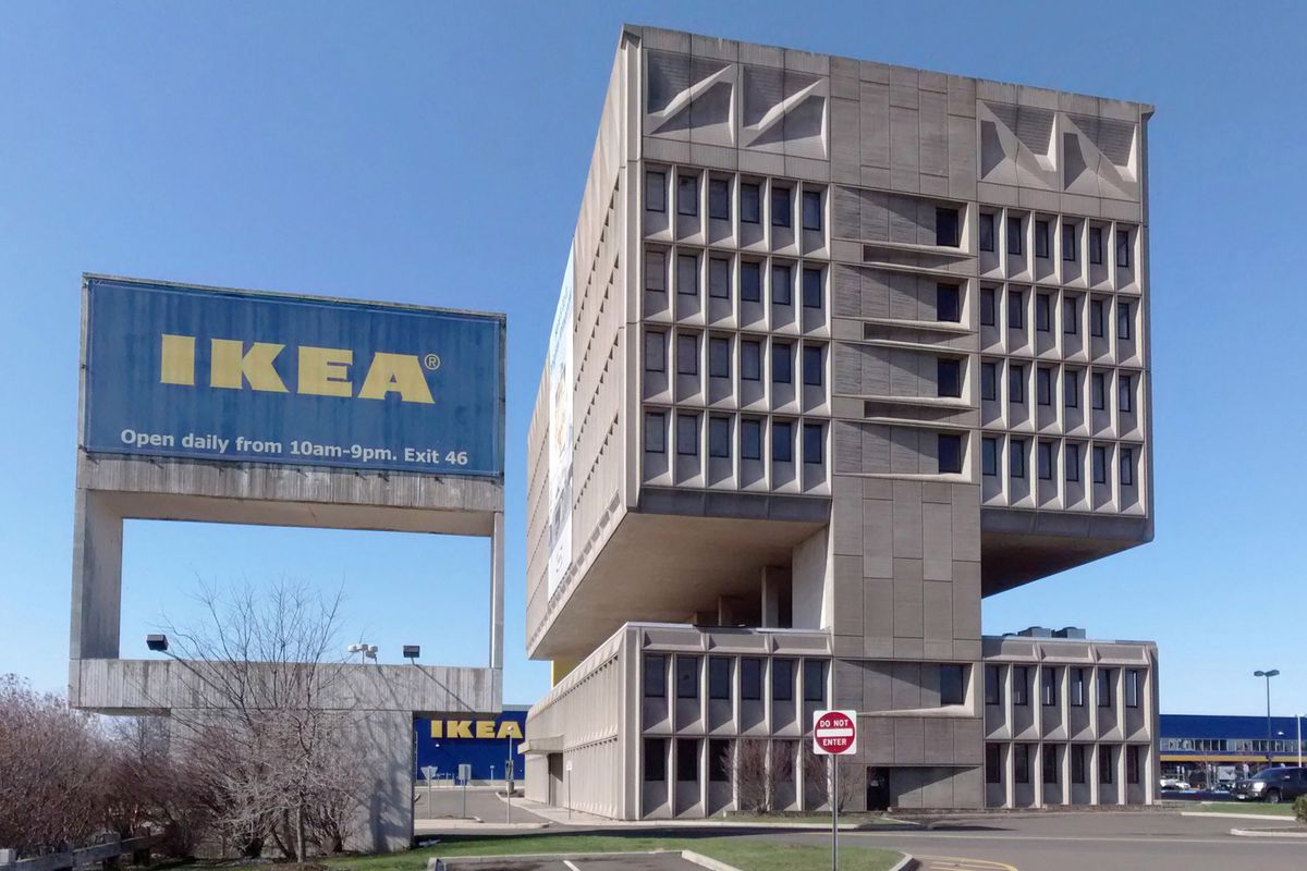 Shot of brutalist building next to Ikea sign.