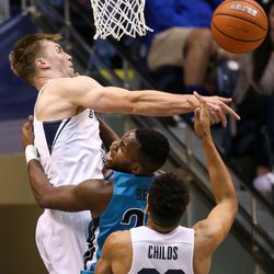 Brigham Young Cougars forward Eric Mika (12) blocks a shot from Coastal Carolina Chanticleers forward Demario Beck (20) during a game at the Marriott Center in Provo on Saturday, Nov. 19, 2016.