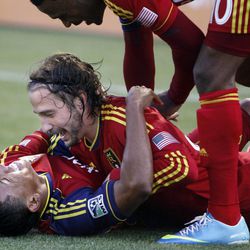 RSL's Joao Plato, bottom, Ned Grabavoy and Robbie Findley celebrate Grabavoy's goal in an MLS game between Real Salt Lake and San Jose at Rio Tinto Stadium in Sandy on Saturday, June 1, 2013. RSL beat the Earthquakes 3-0.