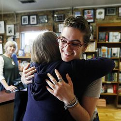 Customer Clare Doornbos, back to camera, hugs bookseller Claire Margetts as she leaves The King's English Bookshop in Salt Lake City on Wednesday, Aug. 23, 2017.