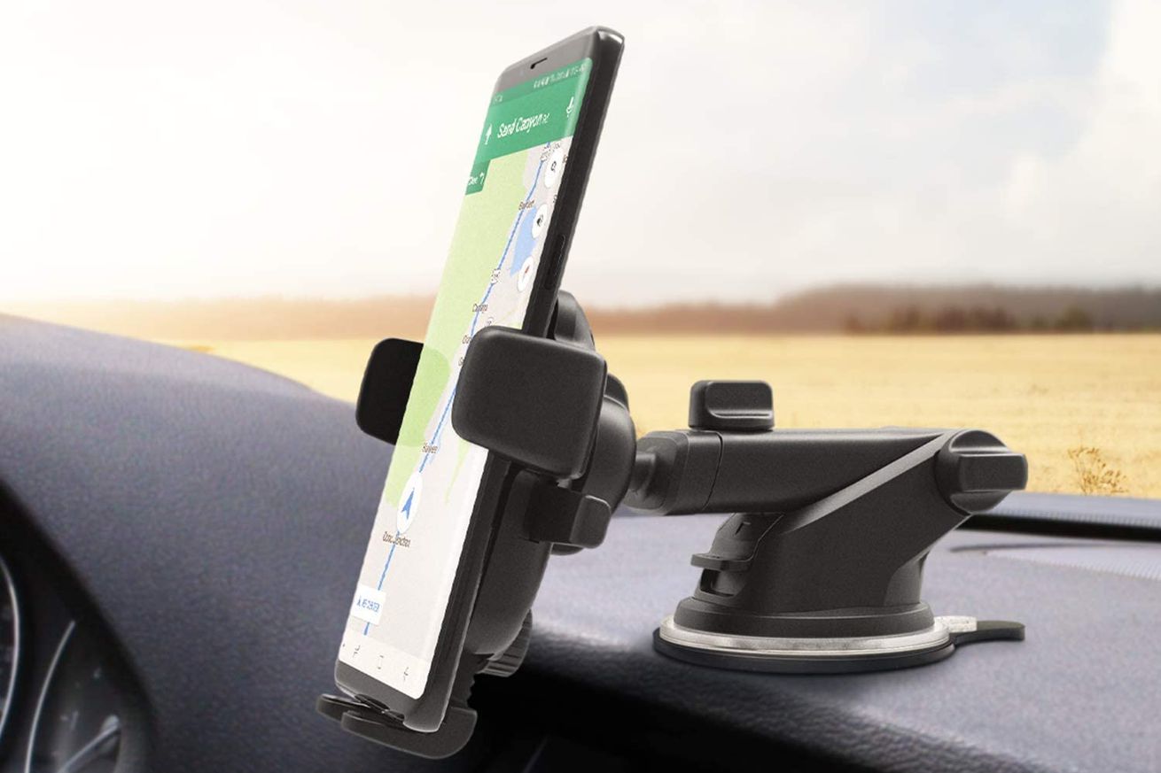 A smartphone attached to a car dash mount.