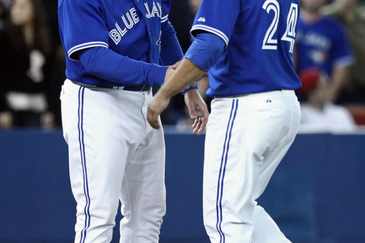 Toronto Blue Jays manager John Farrell congratulates starting pitcher Ricky Romero after defeating the Boston Red Sox at the Rogers Centre. The Blue Jays beat the Red Sox 3-1.