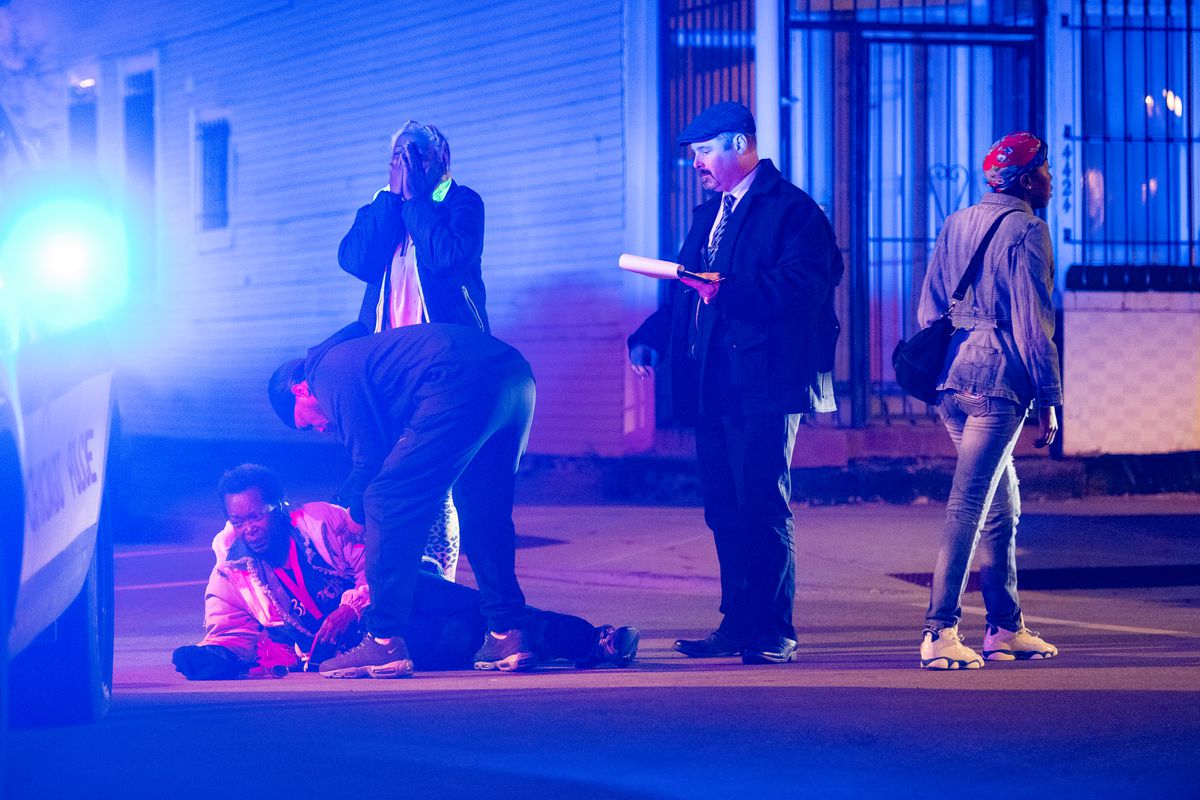 A woman collapses down in grief after finding out her loved one was shot and killed, Sunday night, in the 4400 block of South Wells, in the Fuller Park neighborhood. | Tyler LaRiviere/Sun-Times