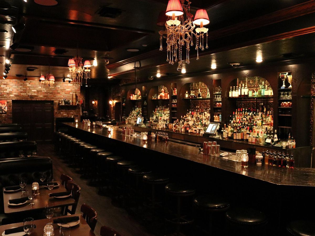 A dark and moody bar with spot lighting