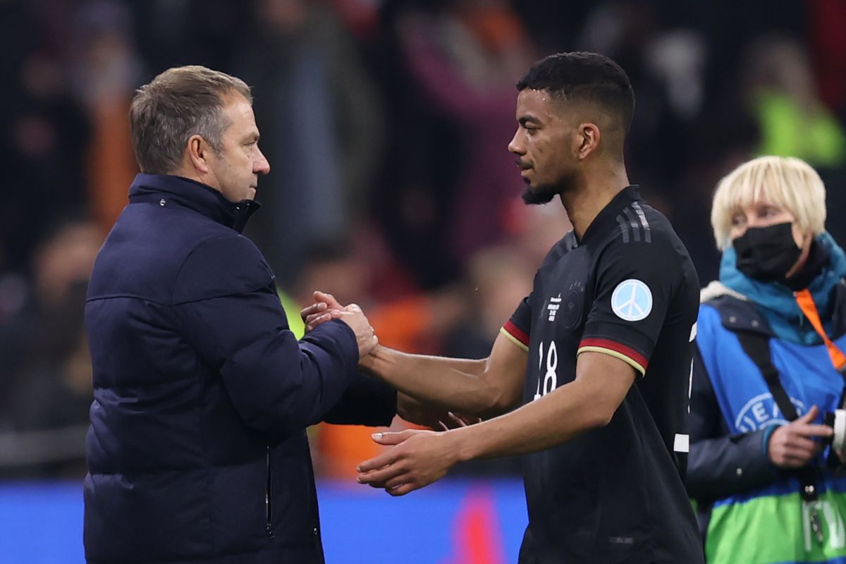 Hansi Flick shakes hands with Lukas Nmecha after an international friendly against Netherlands.