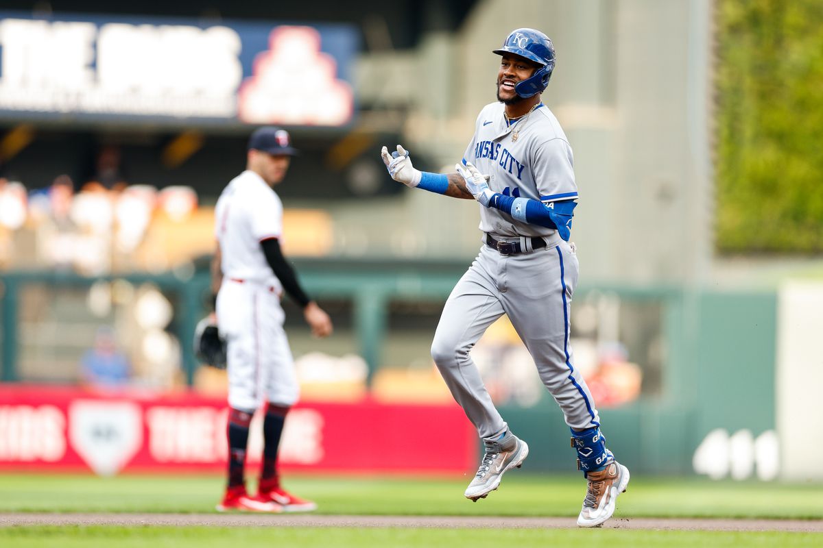 Maikel Garcia #11 of the Kansas City Royals celebrates his solo home run as he rounds the bases while Carlos Correa #4 of the Minnesota Twins reacts in the first inning at Target Field on July 3, 2023 in Minneapolis, Minnesota.