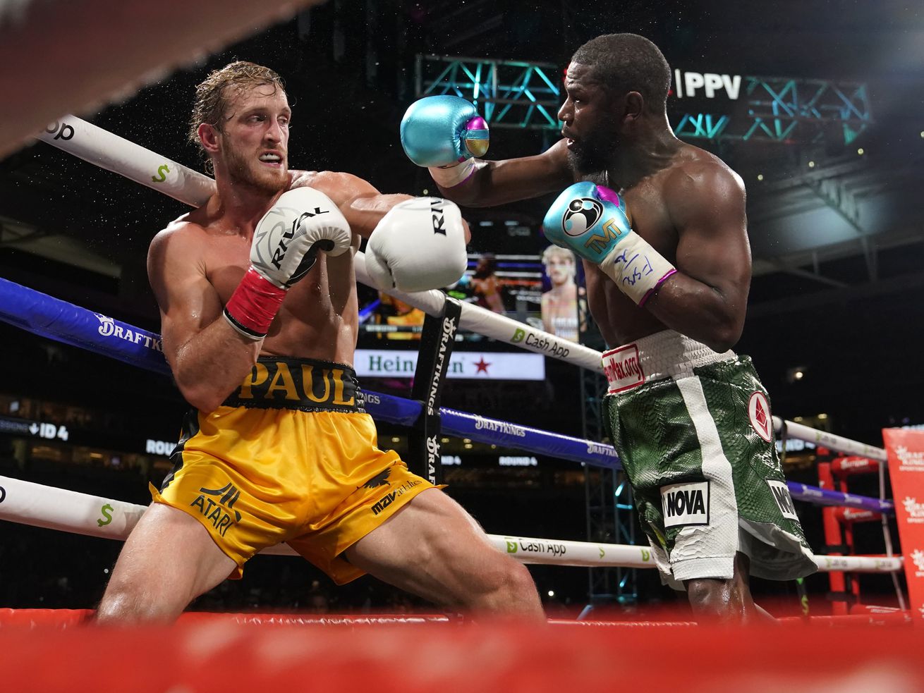 Floyd Mayweather, right, throws a punch at Logan Paul, left, during an exhibition boxing match at Hard Rock Stadium in Miami Gardens, Florida, on Sunday.