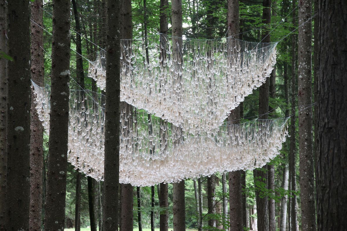 Sculpture hanging between trees