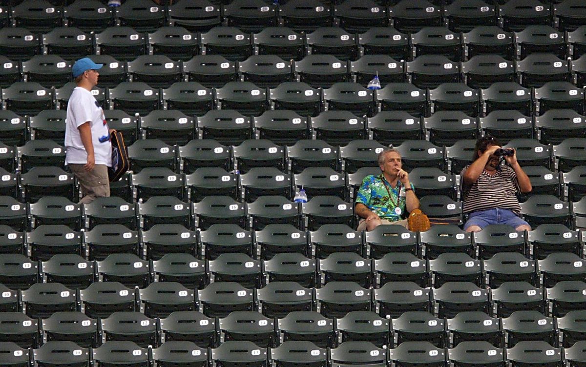 Fans sit in the stands dejected after baseball Com