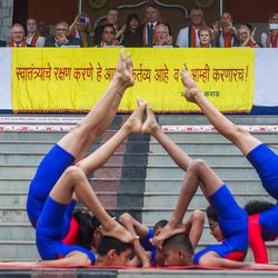 Students perform yogasanas during the 71st Independence Day celebrations at the MIT World Peace University in Pune, Maharashtra, India, on August 15, 2017.