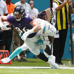Miami Dolphins cornerback Eric Rowe (21) tackles Baltimore Ravens tight end Nick Boyle (86), during the first half at an NFL football game, Sunday, Sept. 8, 2019, in Miami Gardens, Fla. 
