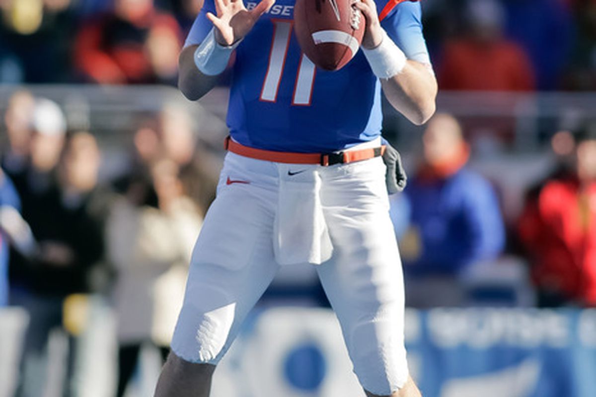 Kellen Moore #11 of the Boise State Broncos looks for a receiver against the Wyoming Cowboys.