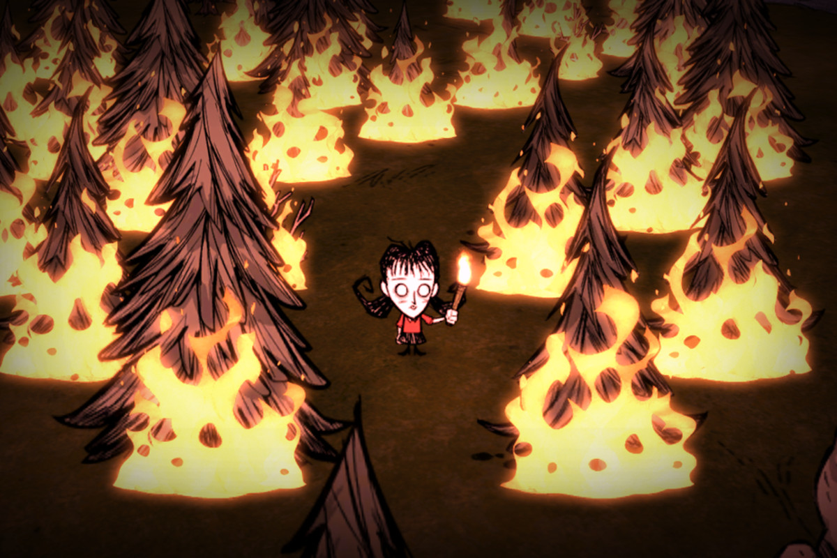 A young woman named Willow stands in the middle of several fires, in the game Don’t Starve Together.